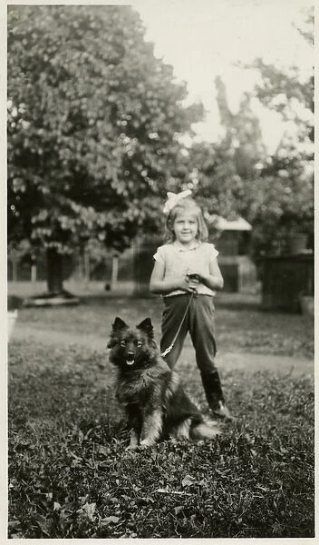 Girl in a park with her dog on a lead