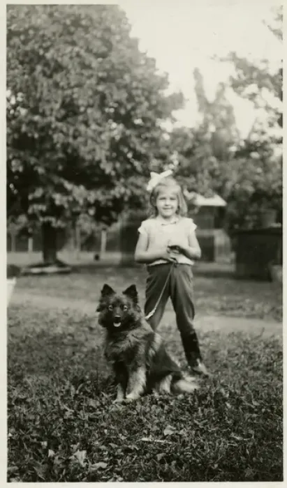 Framed Print : Girl in a park with her dog on a lead Framed Print : Girl in a park with her dog on a lead