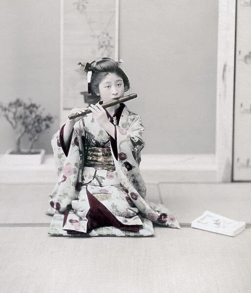 Girl playing a flute, Japan, c. 1890