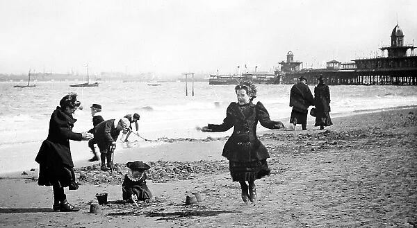 Girl skipping, New Brighton beach and pier