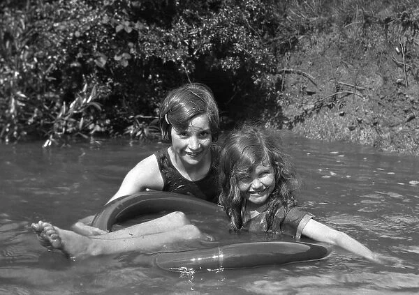 Two girls bathing in a stream