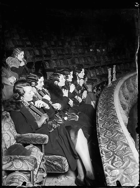 Girls at the Cinema. A group of extremely well turned-out young ladies