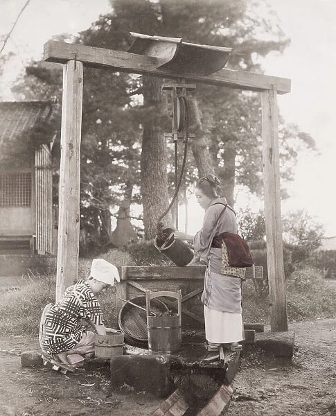 Girls drawing water from a well, with buckets, Japan