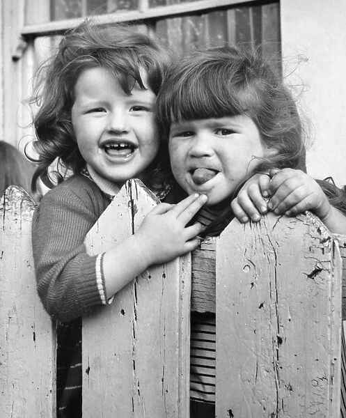 Two girls behind a fence, Balham, SW London
