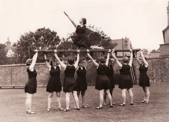 Framed Print : Eight girls hold aloft ninth on gym bench posing with hoop Framed Print : Eight girls hold aloft ninth on gym bench posing with hoop