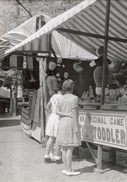 Framed Print : Girls looking at a stall at Looe fair, Cornwall Date: 1930s Framed Print : Girls looking at a stall at Looe fair, Cornwall Date: 1930s