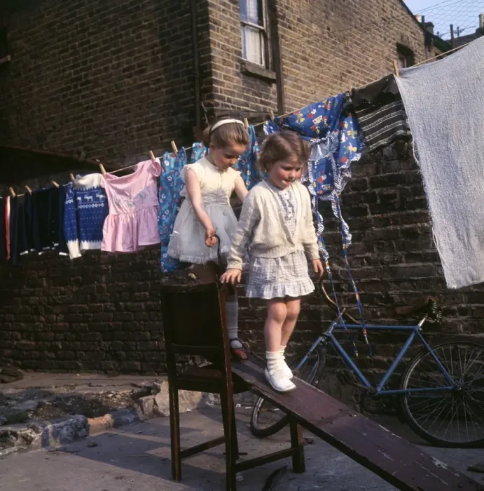 Framed Print : Two girls playing on planks, Balham, SW London Framed Print : Two girls playing on planks, Balham, SW London