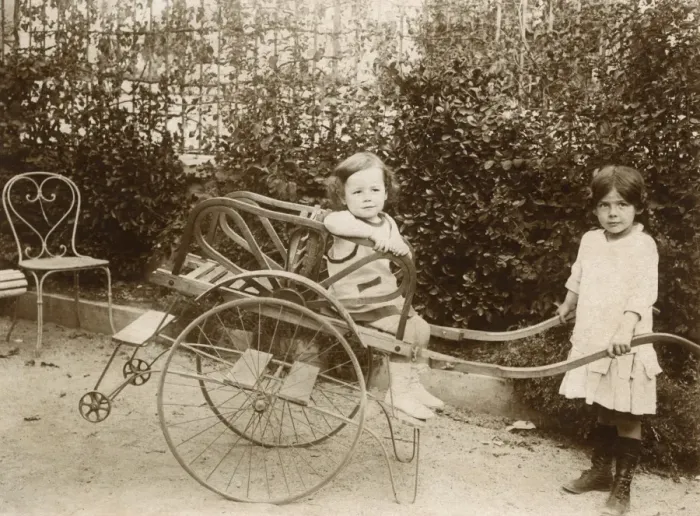 Framed Print : Two girls playing with a push cart Framed Print : Two girls playing with a push cart
