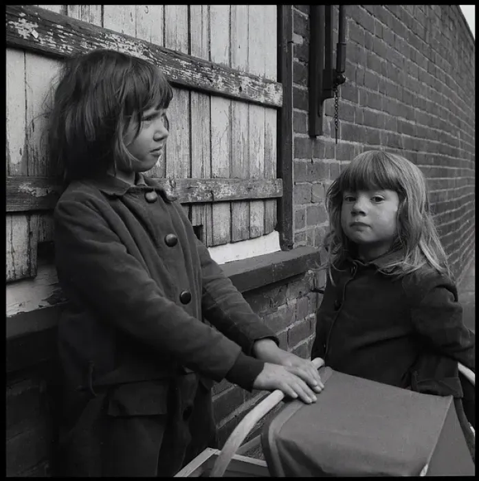 Framed Print : Girls with toy pram in the street Framed Print : Girls with toy pram in the street