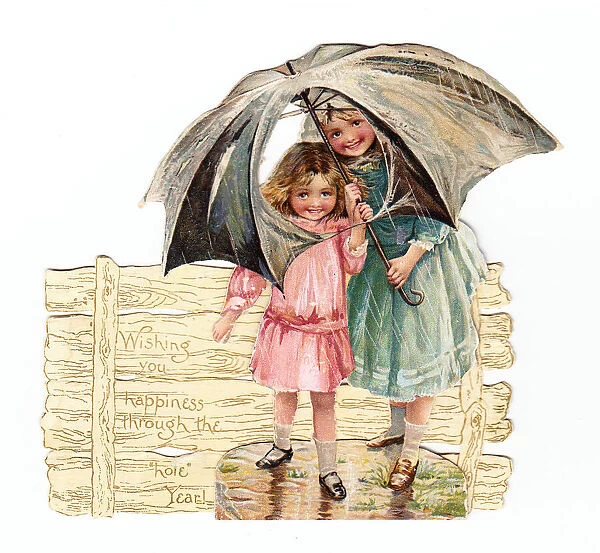 Two girls with umbrella on a cutout New Year card