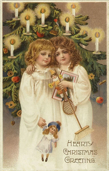 Two girls by Xmas tree