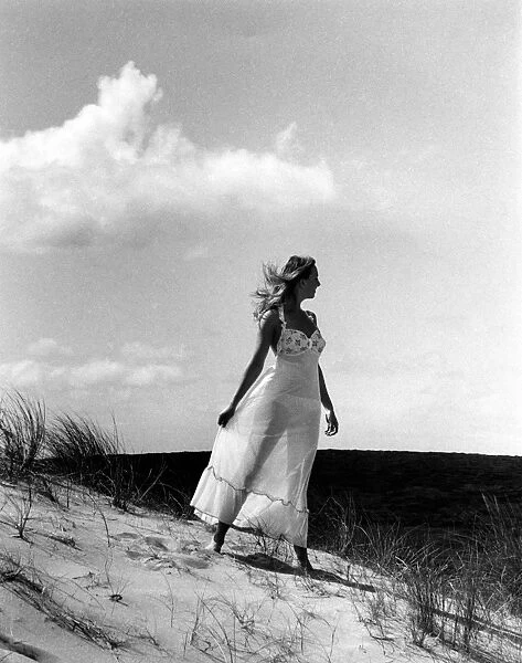 Glamour girl on sand dunes in Cornwall
