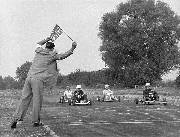 Go-Kart Race 1950S. An official waves a Union Jack flag to start the race. Date: 1950s