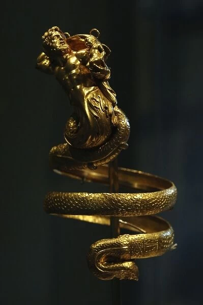 Gold armband with male triton holding a small winged Eros. (