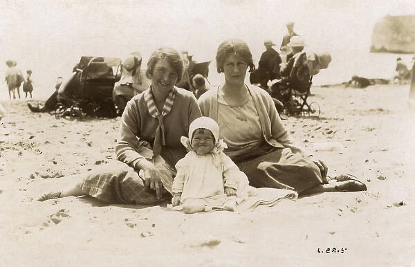 Grandmother, young Mother, and Grandchild - British beach