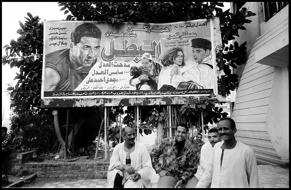 Group of men and film poster Alexandria, Egypt