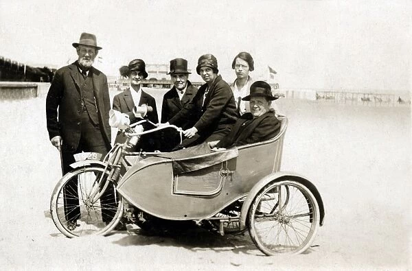 Group of people with vintage motorcycle combination on beach