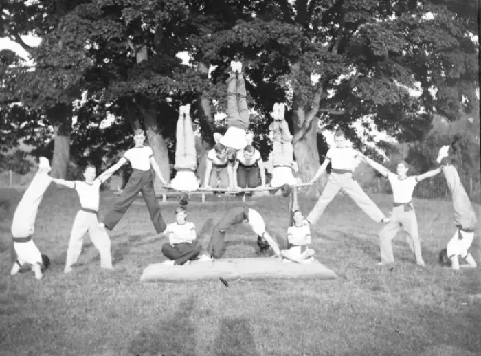 Framed Print : Group of servicemen doing acrobatics in a field Framed Print : Group of servicemen doing acrobatics in a field