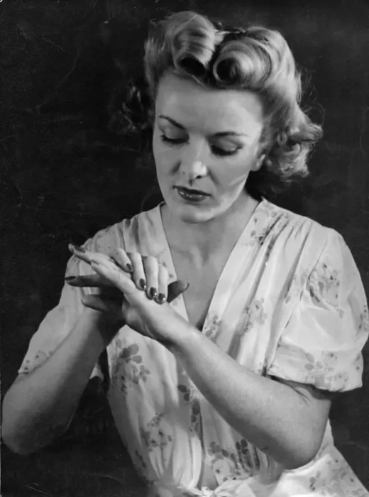 Framed Print : HAND CARE. A stylish model rubs lotion into her lovely hands to keep them soft and supple Framed Print : HAND CARE. A stylish model rubs lotion into her lovely hands to keep them soft and supple