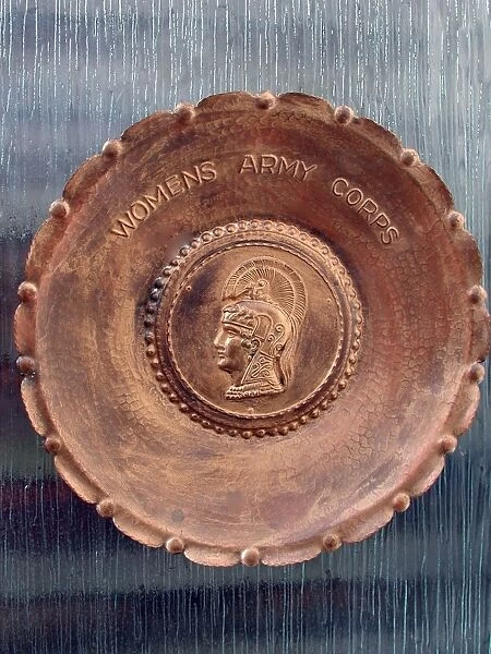 A handmade metal plate, stamped Womens Army Corps