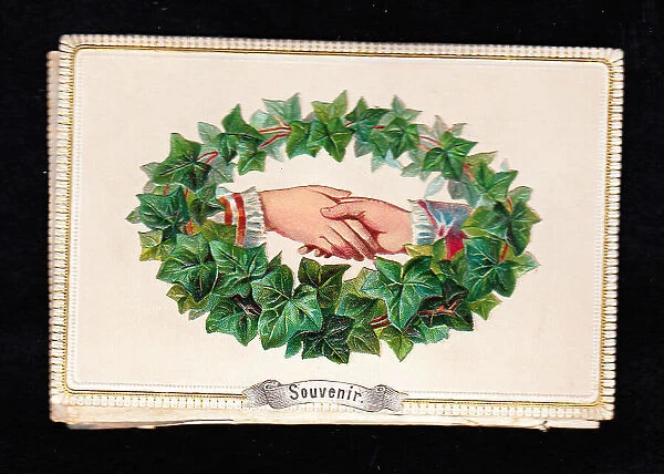 Hands and green leaves on a Souvenir greetings card