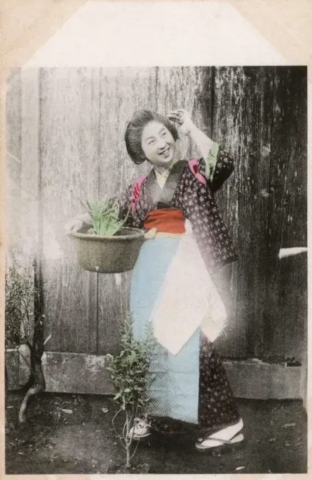 Framed Print : Happy Japanese woman doing a spot of gardening Framed Print : Happy Japanese woman doing a spot of gardening