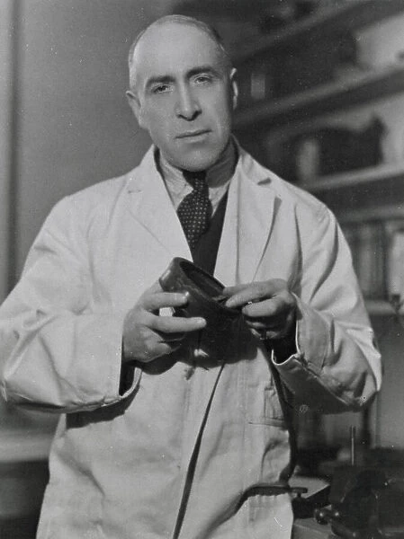 Harry Price (1881 - 1948), psychical researcher and author, in his laboratory