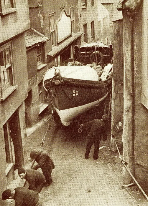 Framed Print : Hauling the lifeboat through a narrow street Framed Print : Hauling the lifeboat through a narrow street