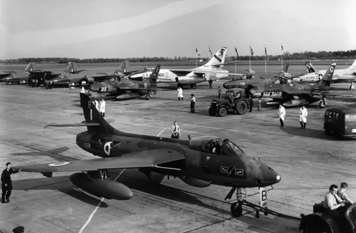 Framed Print : Hawker Hunter F6 XJ714 is towed past a line-up of aircraft Framed Print : Hawker Hunter F6 XJ714 is towed past a line-up of aircraft