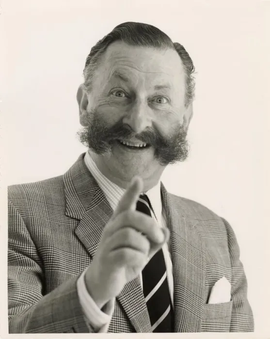 Framed Print : Head and shoulders portrait of a smartly dressed man with a bushy moustache pointing Framed Print : Head and shoulders portrait of a smartly dressed man with a bushy moustache pointing