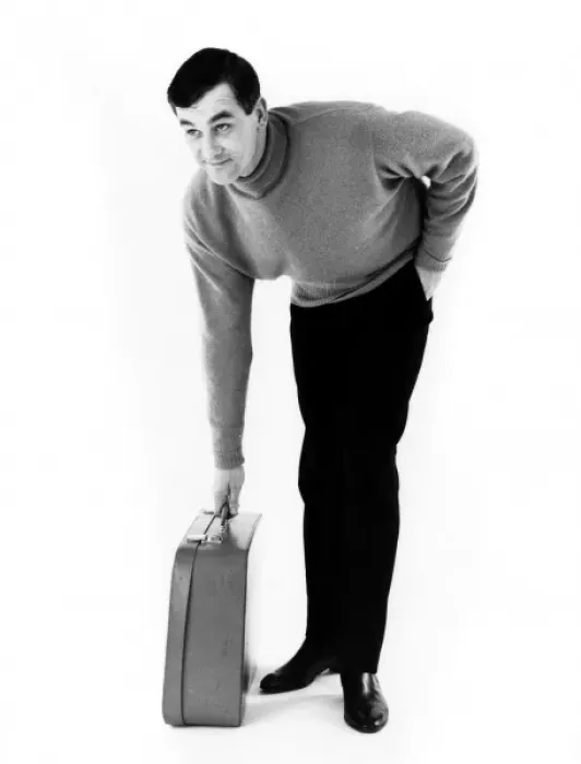 Framed Print : HEs OFF. A man picks up his suitcase. Date: late 1960s Framed Print : HEs OFF. A man picks up his suitcase. Date: late 1960s