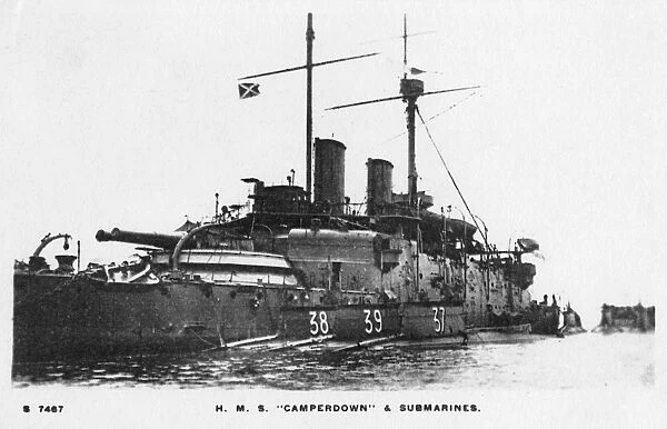 HMS Camperdown with three submarines moored alongside