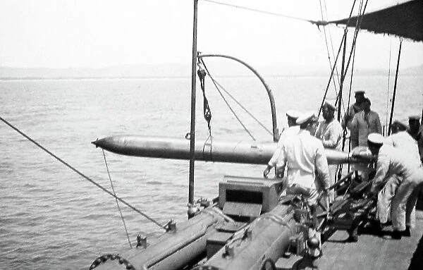 Hoisting a recovered torpedo back on board Royal Navy