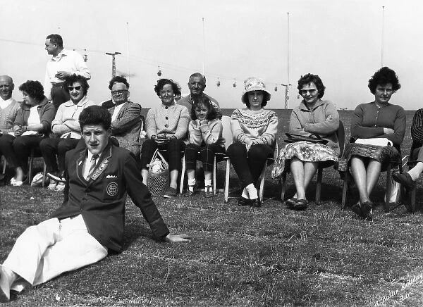 Holidaymakers and a Redcoat at Butlins holiday camp