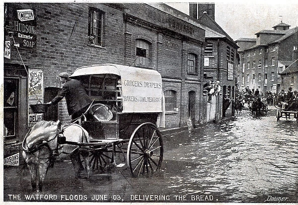 Horse and cart making deliveries in a flooded street