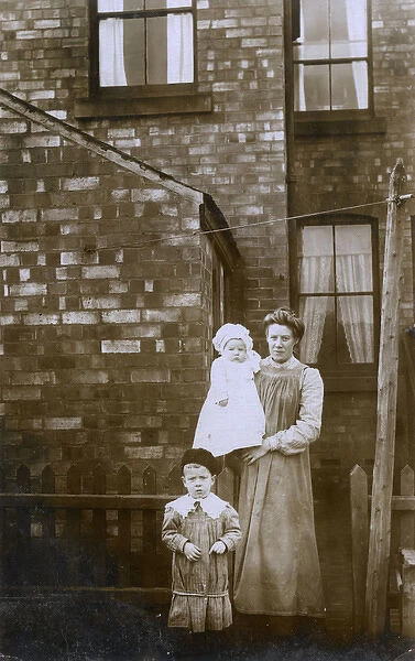 Housewife in the backyard of her terraced home with children