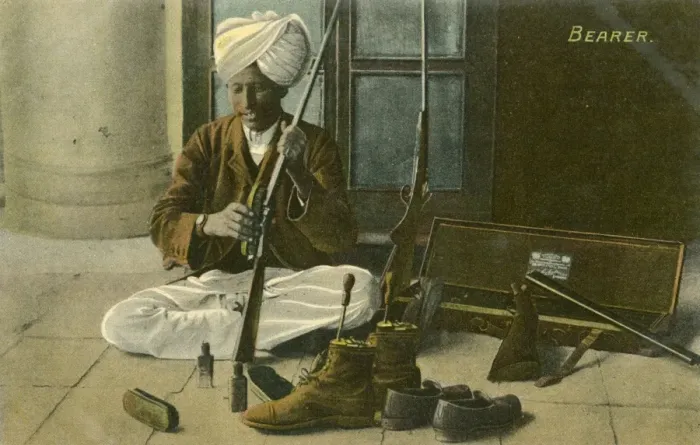 Framed Print : Indian Bearer - cleaning his Masters shoes and rifle Framed Print : Indian Bearer - cleaning his Masters shoes and rifle