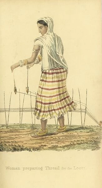 Indian woman preparing thread for the loom