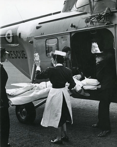 Injured boy loaded into a Westland Whirlwind