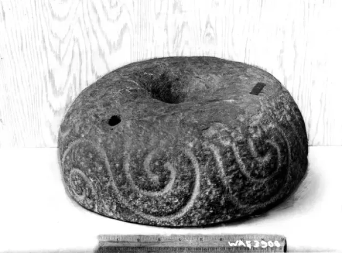 Framed Print : A inscribed round stone with a ruler beside for scale Framed Print : A inscribed round stone with a ruler beside for scale