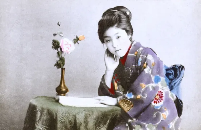 Framed Print : Japan - Geisha Girl - reading a book at a small table Framed Print : Japan - Geisha Girl - reading a book at a small table