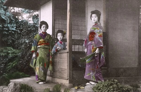 Japan - Three Geisha pose for the photographer by a house