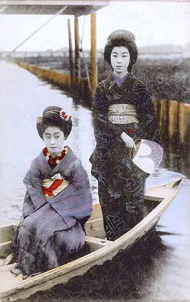 Japan - Two Japanese Geisha Girls pose on a small boat