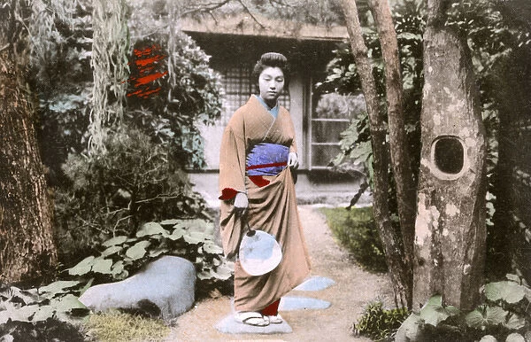 Japan - Woman ( boss at the tea house !) in garden with fan