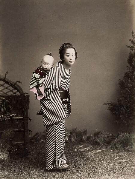 Japan - young nurse carrying a baby