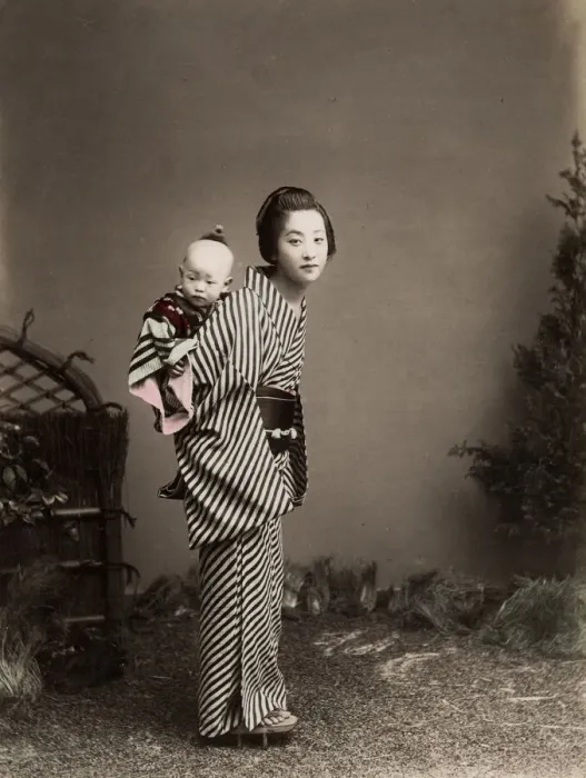 Framed Print : Japan - young nurse carrying a baby Framed Print : Japan - young nurse carrying a baby