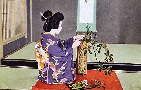 JAPANESE FLOWER ART. A Japanese woman practising Ikebana