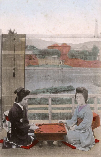 Two Japanese Geisha girls playing crokinole
