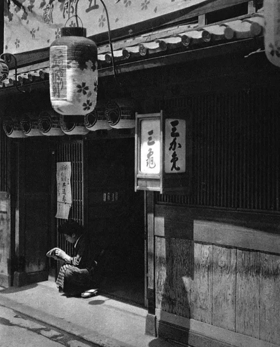 Framed Print : A Japanese girl sits outside a theatre Framed Print : A Japanese girl sits outside a theatre