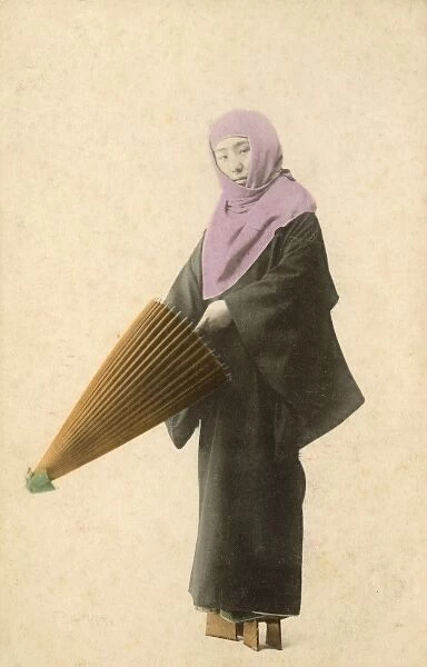 Japanese lady about to unfurl her umbrella